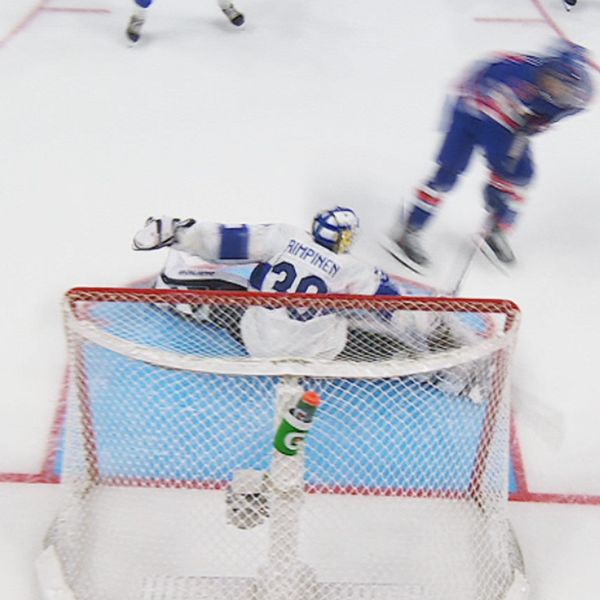 Left section: A hockey player in blue is shooting the puck towards the goal, while the Finnish goalkeeper in white is diving to make a save. Right section: The Finnish goalkeeper is in mid-air, attempting to block a shot, as a player in blue skates past.