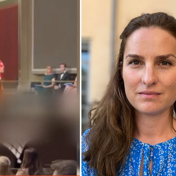 En bild på en person som står i en aula och håller tal och en kvinna i blå tröja