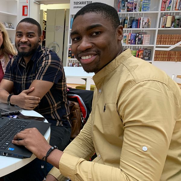 Trois personnes, deux hommes et une femme, sont assises à une table et doivent donner un cours à distance via l'ordinateur.