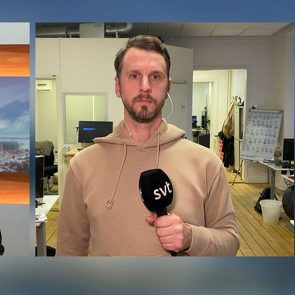 en kvinna i kavaj i en studio och en man i beige huvtröja och skägg