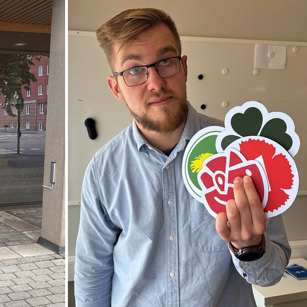 Två män vid Region Östergötlands entré, en håller upp valmaterial med rödgrönt hjärta