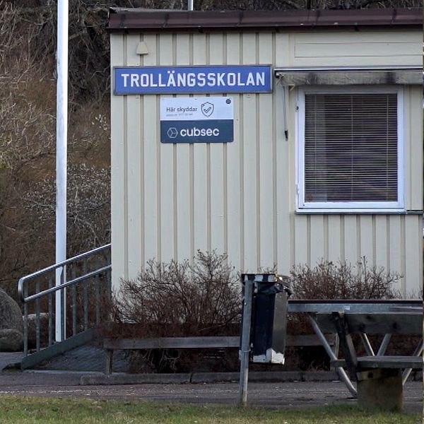 En delad bild som visar två sektioner. På vänster sida syns en person med en otydlig ansiktsbild, klädd i en svart jacka. Till höger finns en byggnad med skylten ”TROLLÄNGSSKOLAN”, där det också står ”cubsec”. Byggnaden har ett fönster och några bänkar framför.