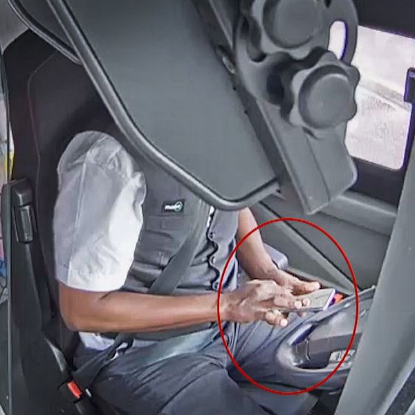 En av Västtrafiks busschaufförer åtalas för vårdslöshet efter att krockat med en stolpe i Bergsjön när han använde mobilen samtidigt som han körde bussen.
