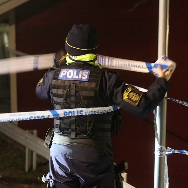 SVT:s reporter i Strängnäs och polis som sätter upp avspärrning