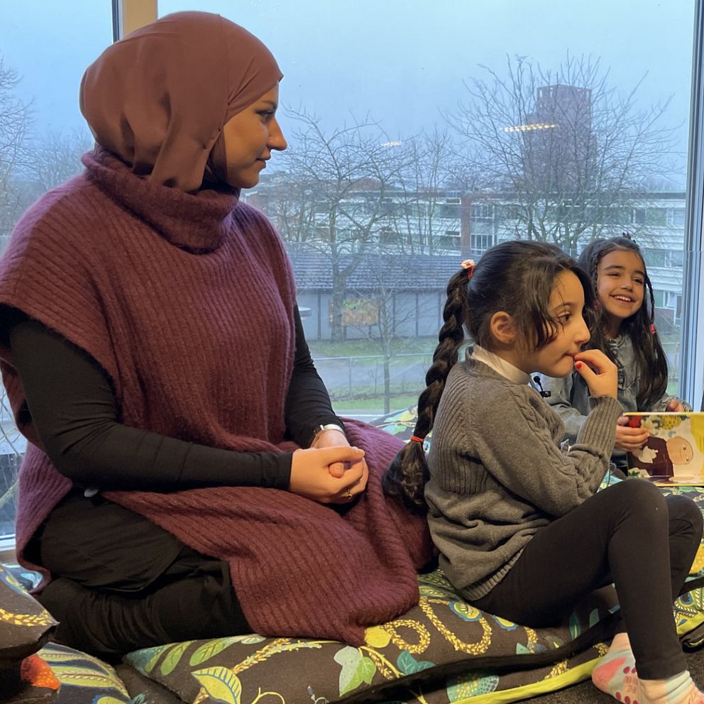 Duha Salomi besöker förskola på Drottninghög och läser för sin dotter.