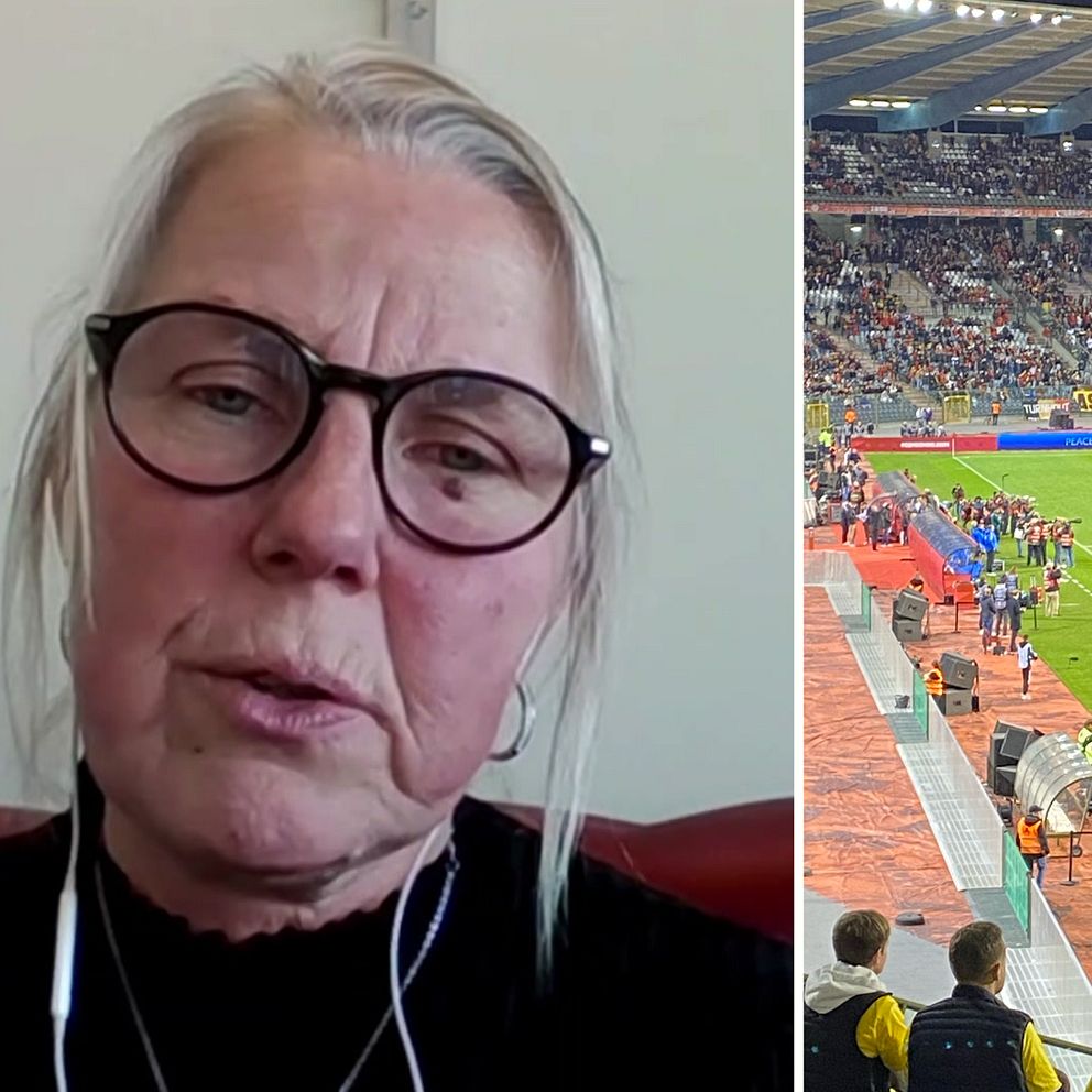 En äldre dam i glasögon, Monica Vester, sitter mot en vit vägg. Till höger syns insidan av fotbollsarenan i Bryssel.