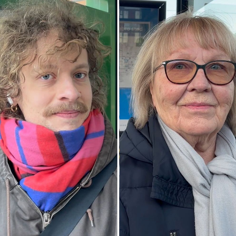 Två personer står vid en busshållplats på Örebro tågstation, i samband med nya linjenät för stadsbussarna i Örebro. Den vänstra personen har en rutig halsduk i färgerna blått, rött och svart, samt en svart jacka. Den högra personen bär en svart jacka och en ljusgrå halsduk. I bakgrunden syns en stadsbild med byggnader och en tågperrong.