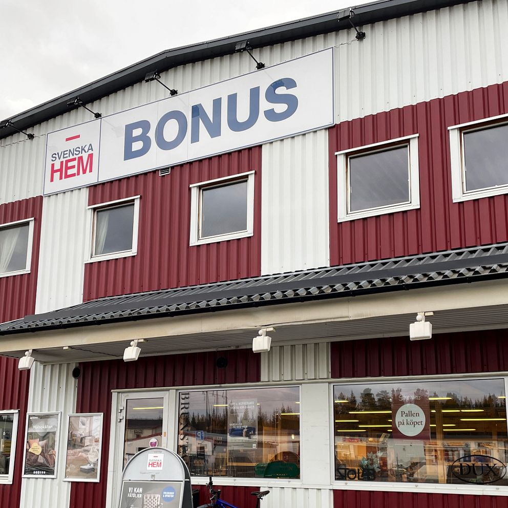 Framsidan av en byggnad som har röda och vita väggar. En stor skylt med texten ”BONUS” sitter över entrén.