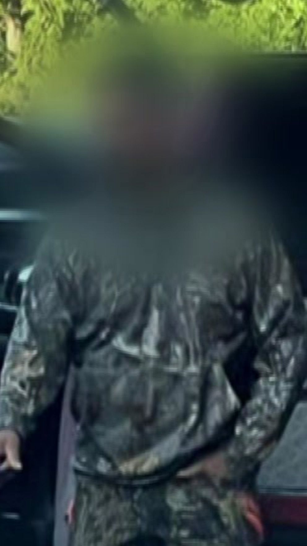 Två suddiga personer står vid en öppnad bil med ett djurbur.