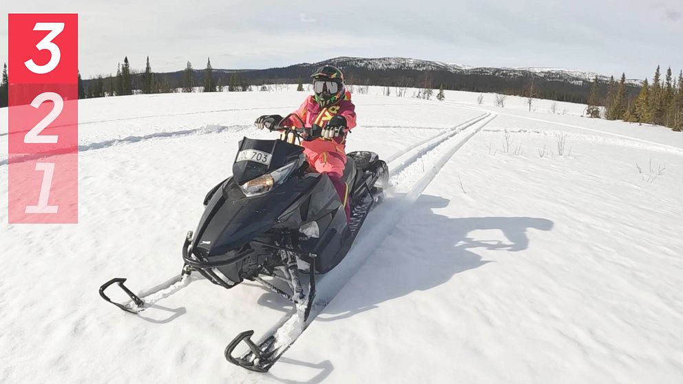 En kvinna på en skoter på en solig myr