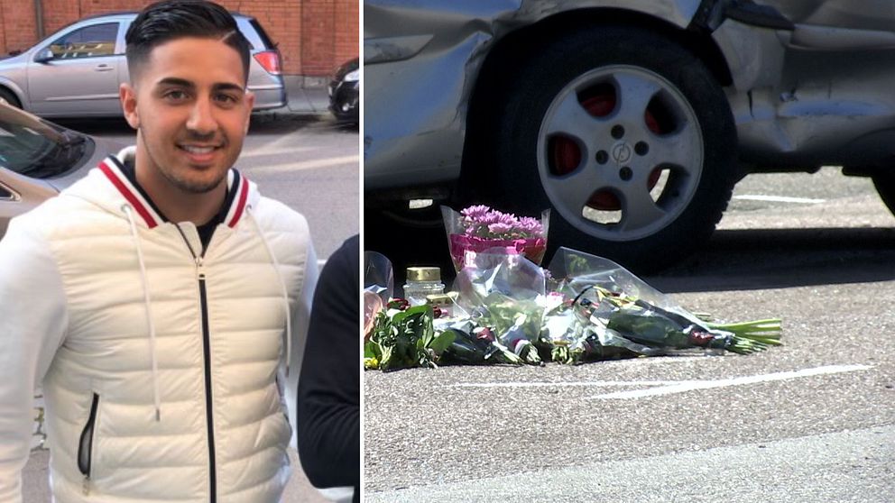 En ung man i vit jacka ler in i kameran, till höger ligger blommor på marken intill en bil.