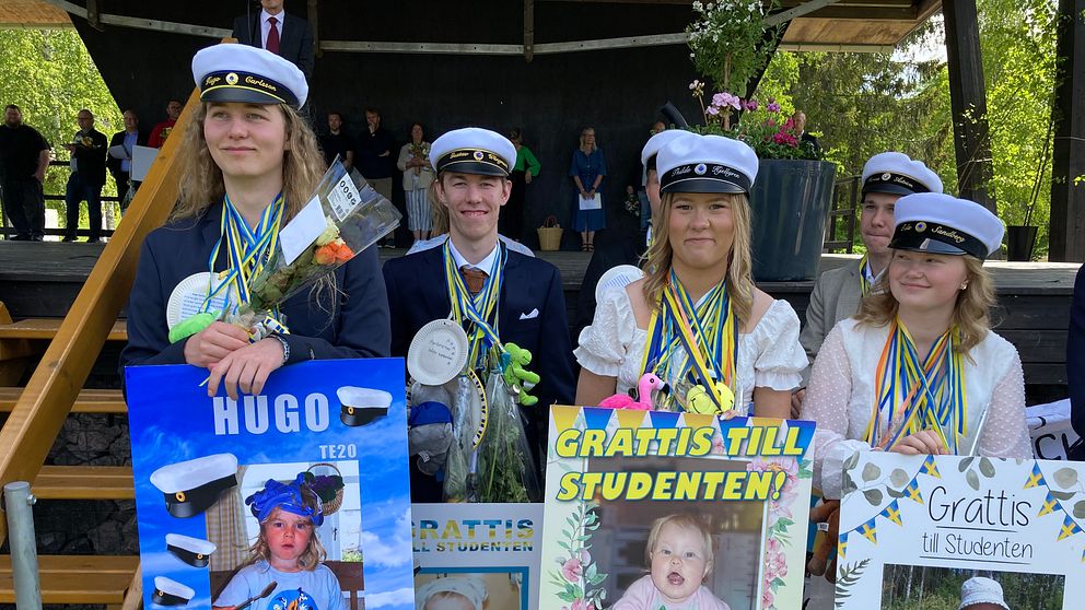 Fyra studenter med skyltar