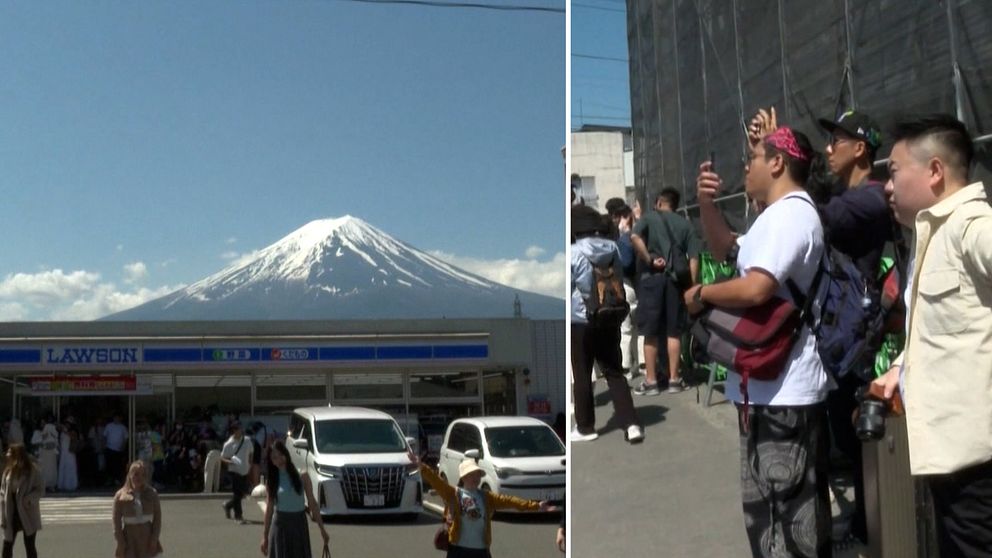 Turister står i en klunga och fotograferar berget Fuji.
