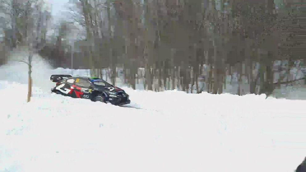 Rallybil kör längs snötäckt väg vid strandpromenaden i Umeå.