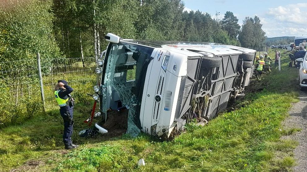 en buss med kraschade rutor ligger i diket