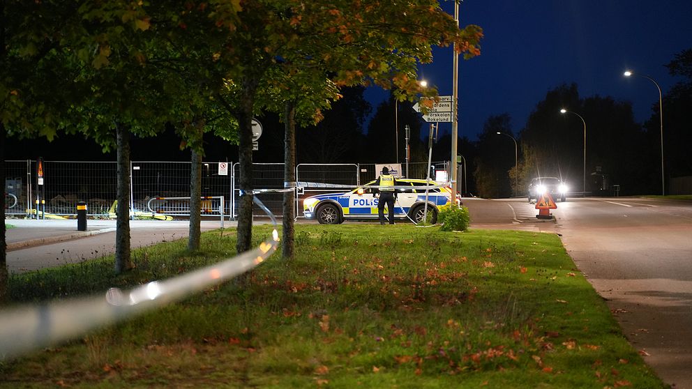 gräsmatta och träd vid polisens avspärrningar, vid bilväg i Araby i Växjö