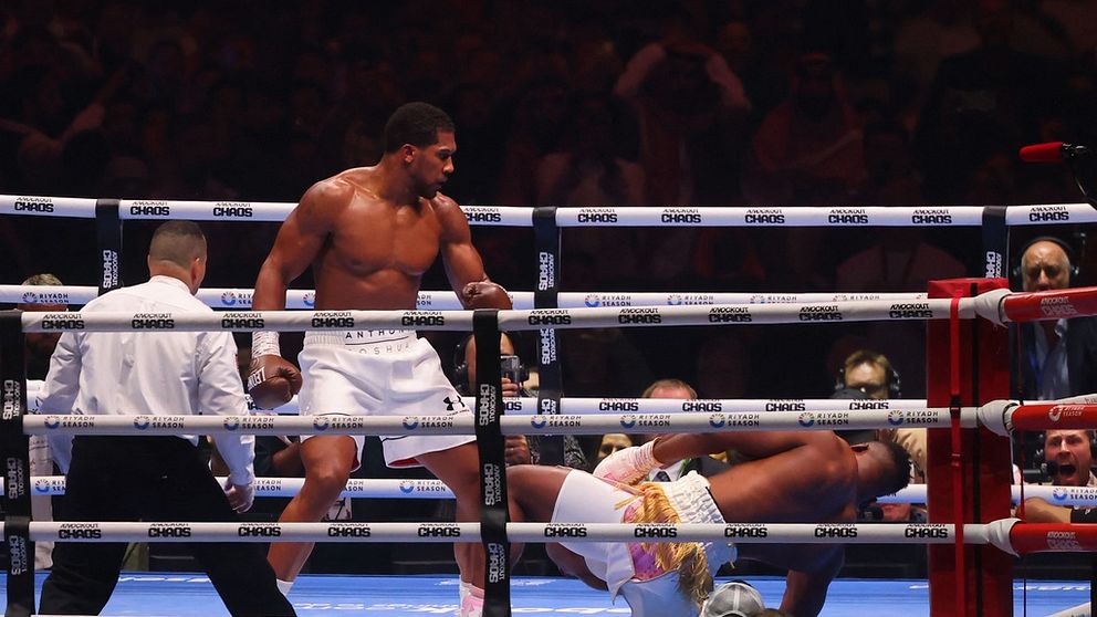 Anthony Joshua golvar motståndaren Francis Ngannou i boxningsringen.