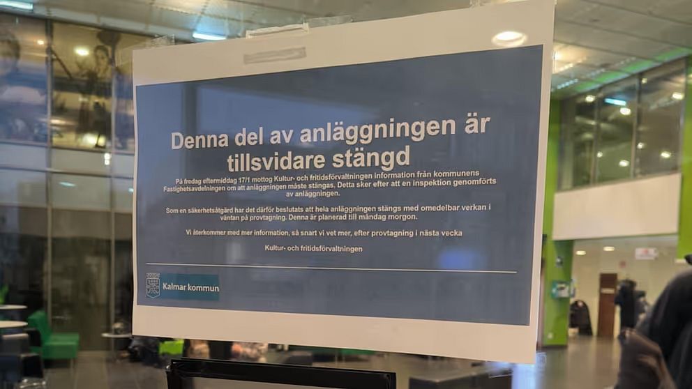Skylt som informerar om att hela Äventyrsbadet i Kalmar tillfälligt är stängd. Skylten är placerad i en offentlig miljö med moderna inslag.