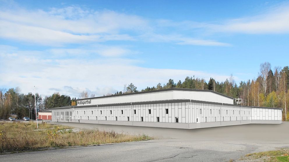 En modern byggnad med vit fasad och stora fönster, belägen vid en asfalterad väg. Multisportarenan som planeras i Örnsköldsvik.