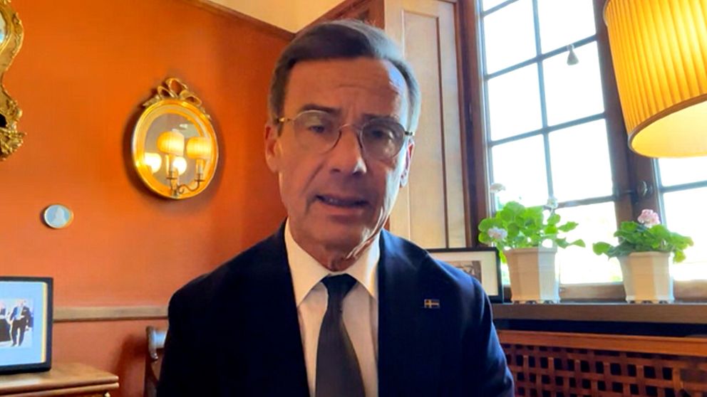 Statsminister Ulf Kristersson sitter inomhus, tittar in i kameran.