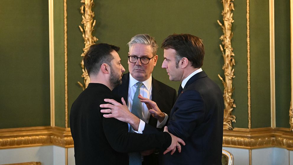 Volodymyr Zelenskyy samtalar med Emmanuel Macron i en elegant sal.
