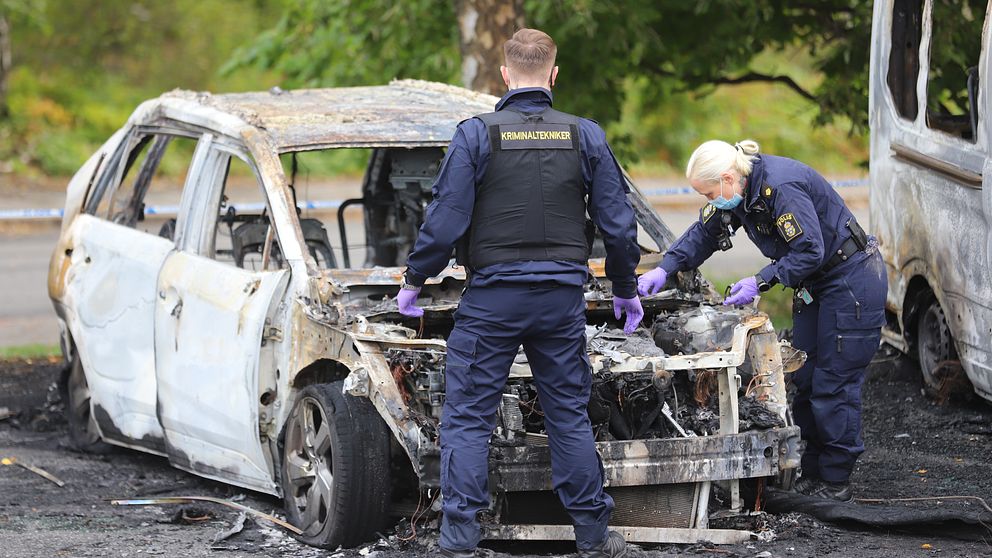 Polisens tekniker undersöker om det är nått samband mellan en utbränd bil i Skärholmen och mordet i Fruängen
