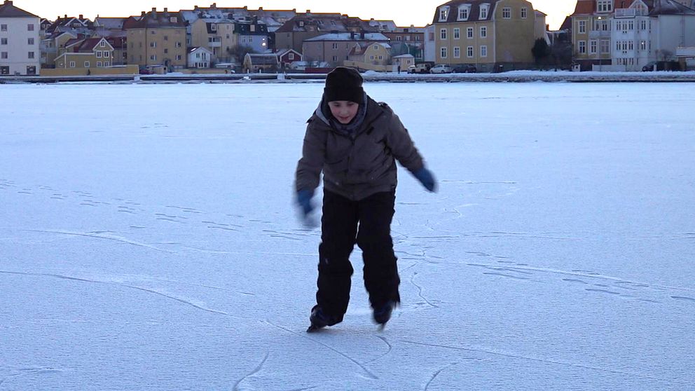 Pojke på snötäckt is.