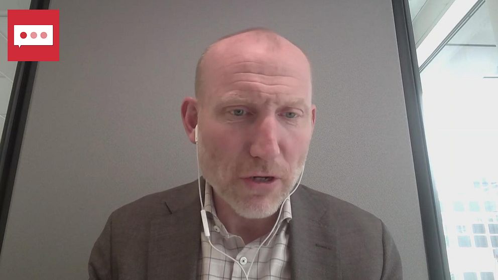 Man i kostym sitter i ett kontorsrum under en videointervju.
