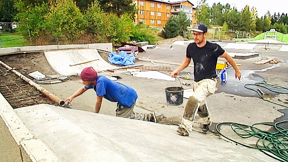 Conny Björklund putsar för att få till rätt kurvning på en ramp medan Joakim Lovén kommer med en ny hink med betong.