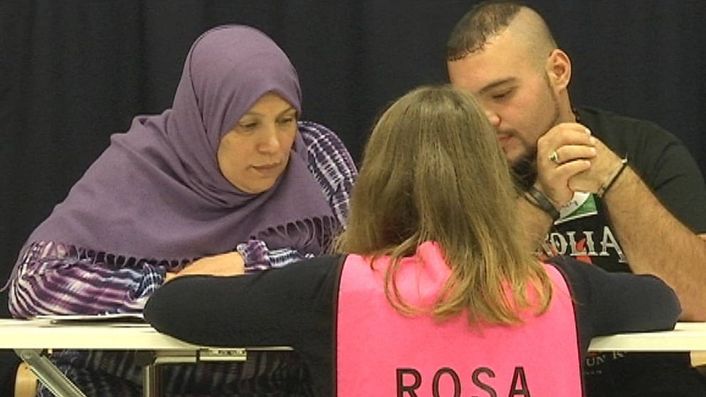 Två ”elever” får hjälp att lära sig svenska av en från Refugees Welcome.