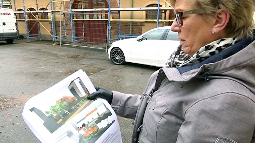 Britten Ulin visar byggnadsritningen för nya kvinnohuset.