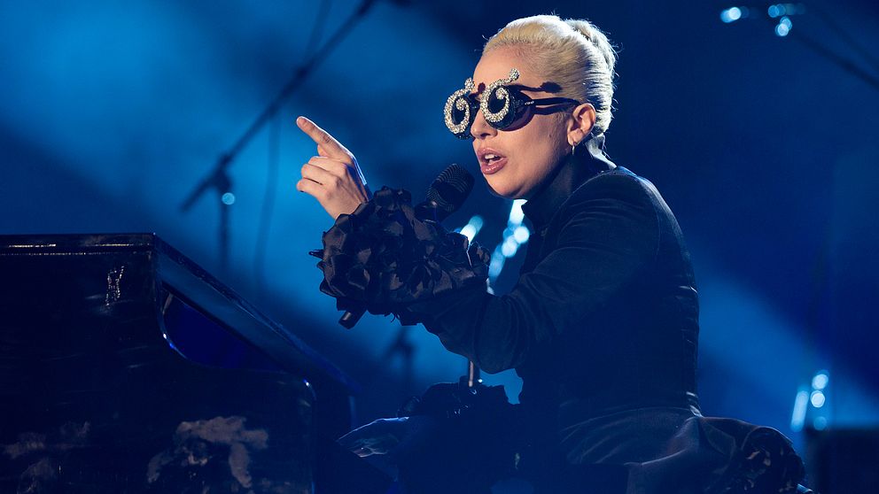 Lady Gaga sitter vid ett piano.