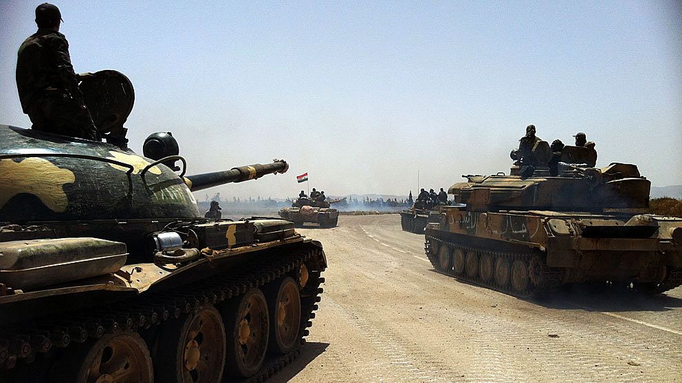 This photo taken by mobile phone on June 2, 2013 shows Syrian army tanks making their way to the Dabaa military airfield, north of the Syrian city of Qusayr. Syrian regime troops repulsed a rebel assault on a village loyal to President Bashar al-Assad in central Homs province, killing at least 28 of the attackers, the Syrian Observatory for Human Rights said. AFP PHOTO/STR