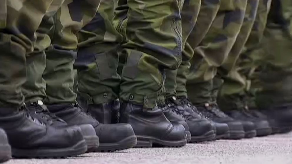 soldaters ben med kamouflagebyxor och kängor
