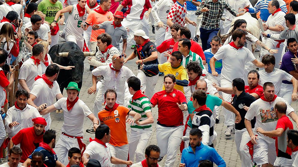 A Fuente Ymbro ranch fighting bull runs with revelers during the running of the bulls of the San Fermin festival, in Pamplona, Spain, Saturday, July 13, 2013. Revelers from around the world arrive to Pamplona every year to take part on some of the eight days of the running of the bulls glorified by Ernest Hemingway's 1926 novel 'The Sun Also Rises.' (AP Photo/Daniel Ochoa de Olza)