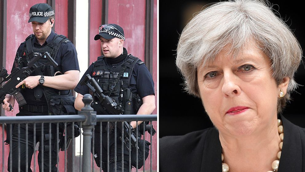 Premiärminister Theresa May och två beväpnade poliser.