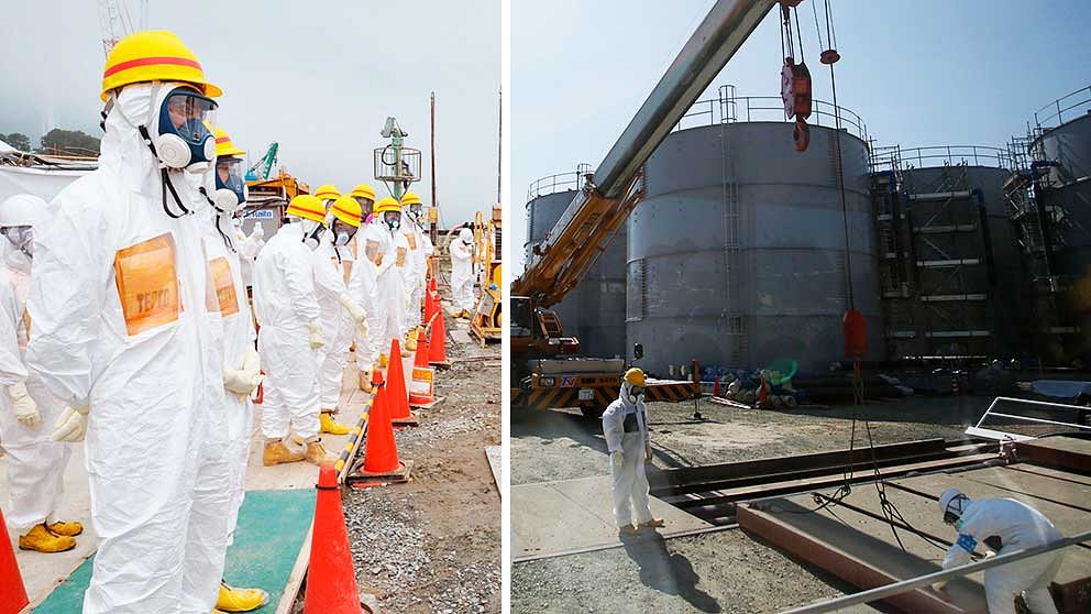 Personal i skyddskläder övervakar arbetet med att bygga en barriär som ska stoppa läckan av radioaktivt vatten vi d Fukushima.