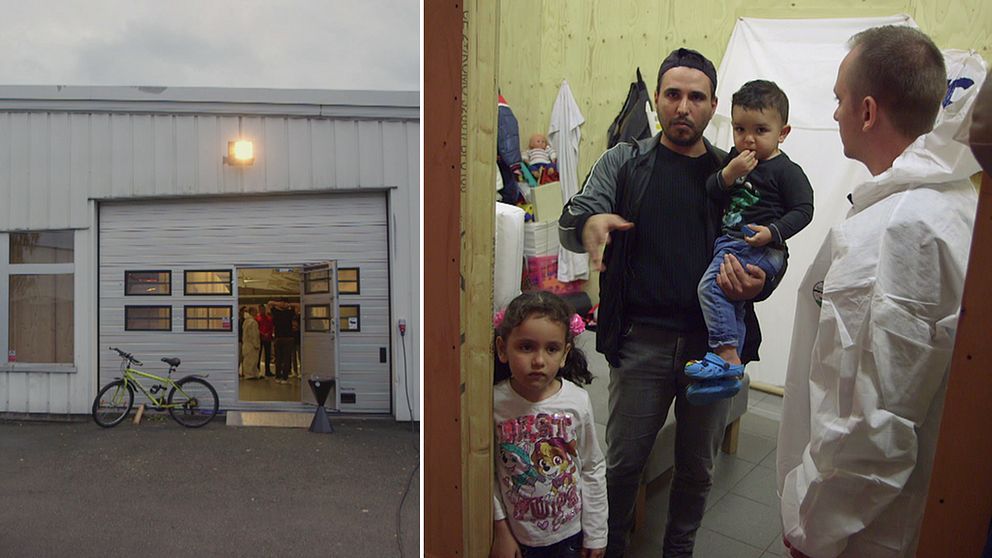 SVT:s reporter David Boati i skyddsdräkt tillsammans med en familj med nyanlända som bor i den gamla bilhallen.
