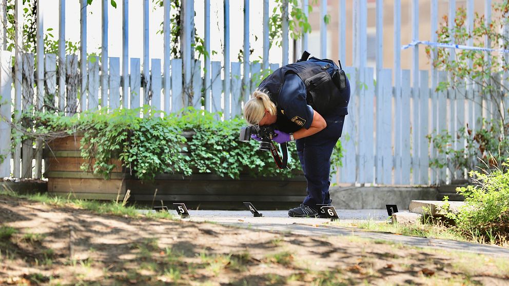 En polis som undersöker platsen där mannen sköts av polisen.