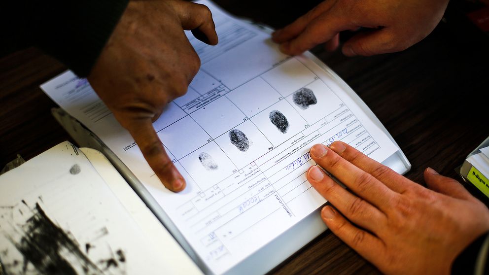 En person lämnar fingeravtryck i samband med en asylansökan