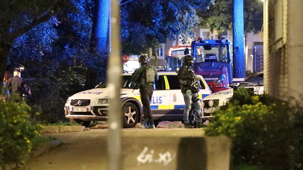 Tungt beväpnade poliser i Bagarmossen efter skottlossningen.