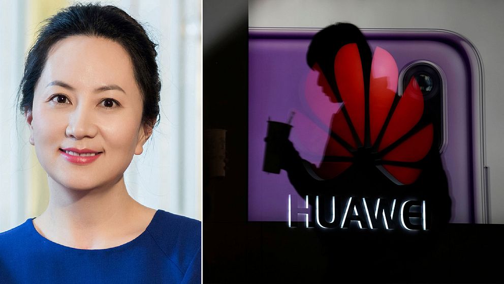 Huaweis finanschef Meng Wanzhou och en man framför företagets logotyp