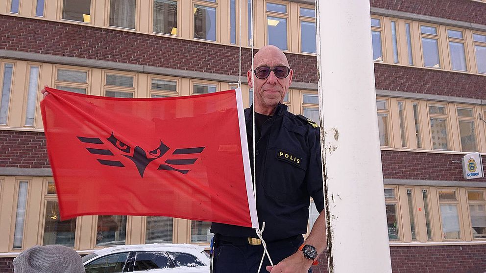 Stationsbefäl B-G Strandfjäll halar ÖFKs supportflagga som hissats utanför Sundsvalls polishus på torsdagen.