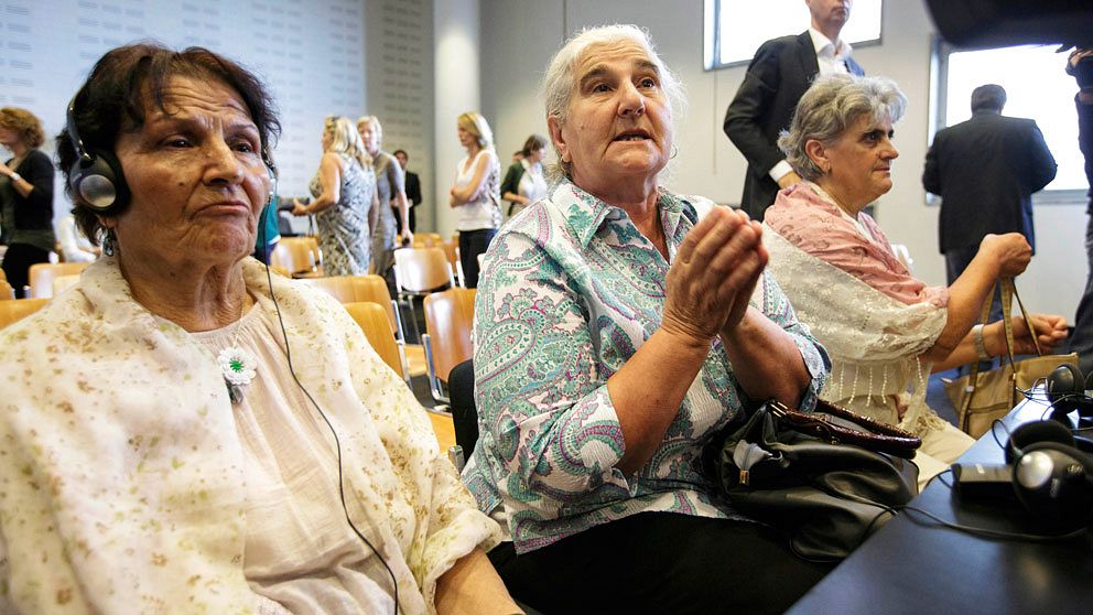 Women from the Bosnian town of Srebrenica wait for judges to enter a civil court in The Hague, Netherlands, Wednesday, July 16, 2014. A Dutch court has declared the country liable in the deaths of more than 300 Bosnian Muslim men murdered by Bosnian Serb forces in the United Nations-declared Srebrenica 'safe haven' 19 years ago and ordered the government to pay compensation to their widows and families. The decision was only a partial victory for families of some 8,000 men slain in the July 1995 Srebrenica massacre. In an emotionally charged hearing judges said that Dutch UN peacekeepers should have known that more than 300 men deported from the Dutch compound by Bosnian Serb forces on July 13, 1995, would be murdered. (AP Photo/Phil Nijhuis)