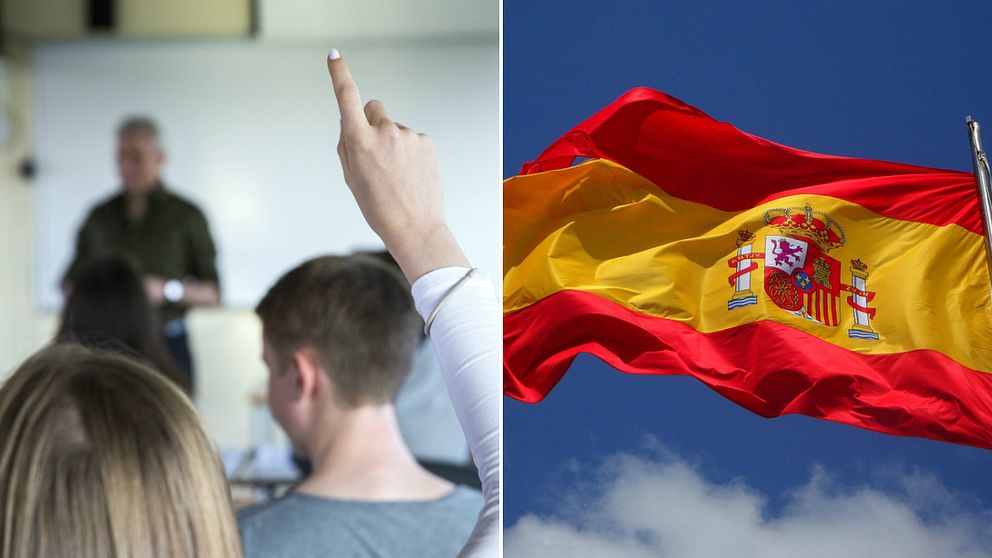 En elev räcker upp handen i ett klassrum bredvid en spanska flagga.