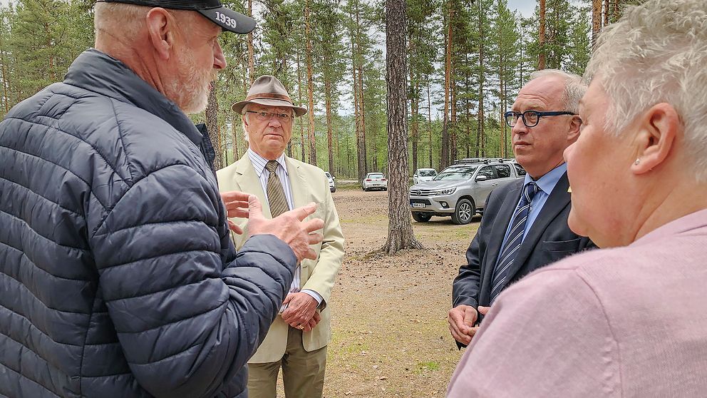 Kung Carl Gustaf samtalar med Per Bill och två boende i brandområdet i Kårböle.