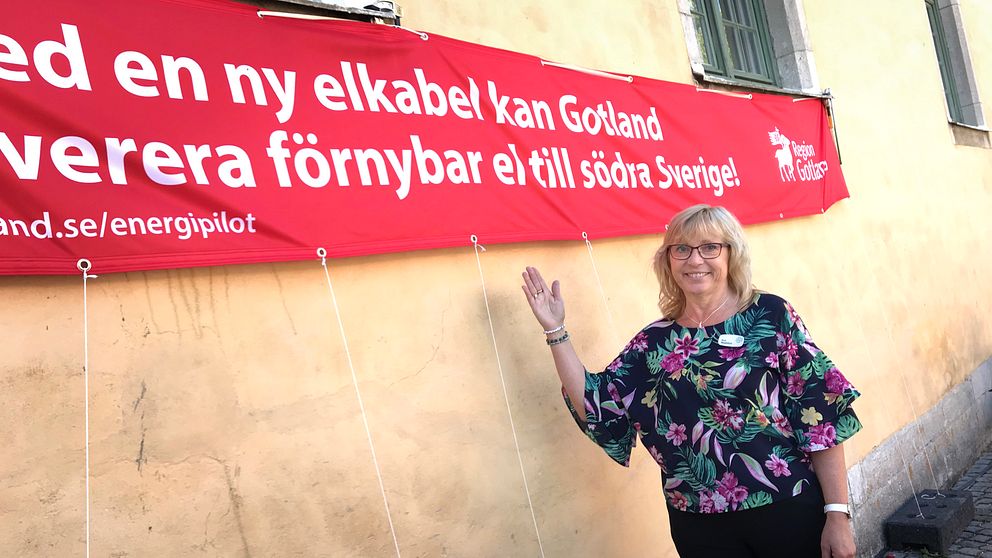 Eva Nypelius (C), ordförande för regionstyrelsen på Gotland, framför en banderoll.