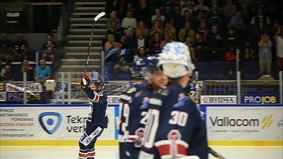 Sebastian Karlsson åker på isen med höjd klubba inför publik.