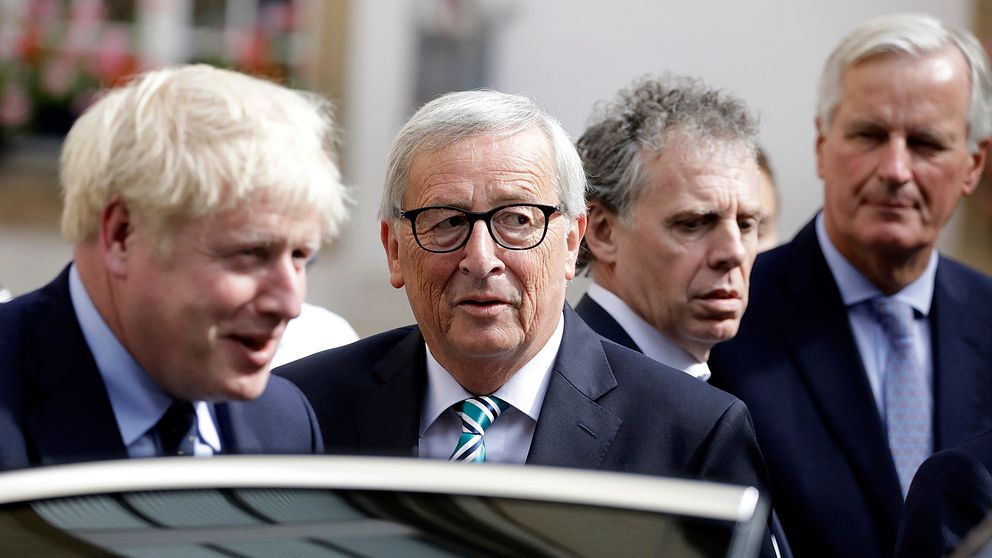 EU-kommissionens ordförande Jean-Claude Juncker och brittiske premiärministern Boris Johnson står brevid varandra, vid en öppen bildörr.