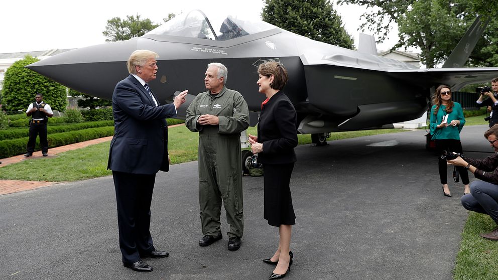 President Donald Trump tillsammans med Lockheed Martins styrelseordförande och vd Marillyn Hewson och en testpilot framför ett F-35 stridsflygplan i juli 2018.